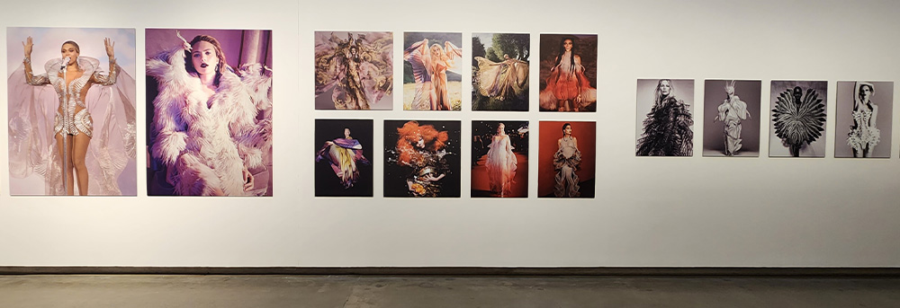 A gallery wall with pictures of Iris Van Herpens work